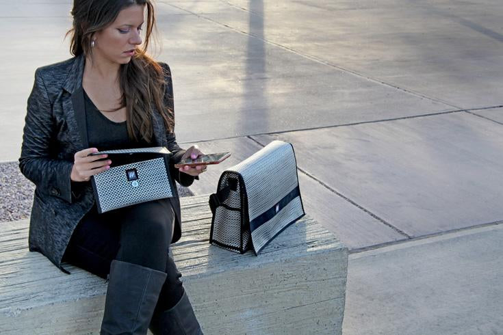 woman taking phone out of bag